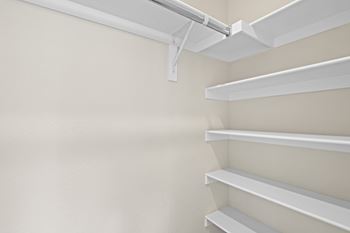 Empty white shelves in a room.